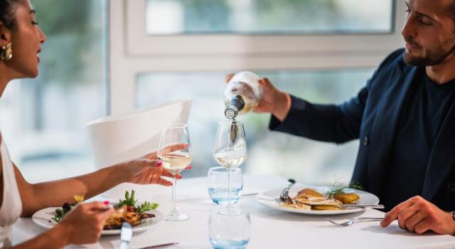 Romantic dinner with white wine, elegant and intimate atmosphere.