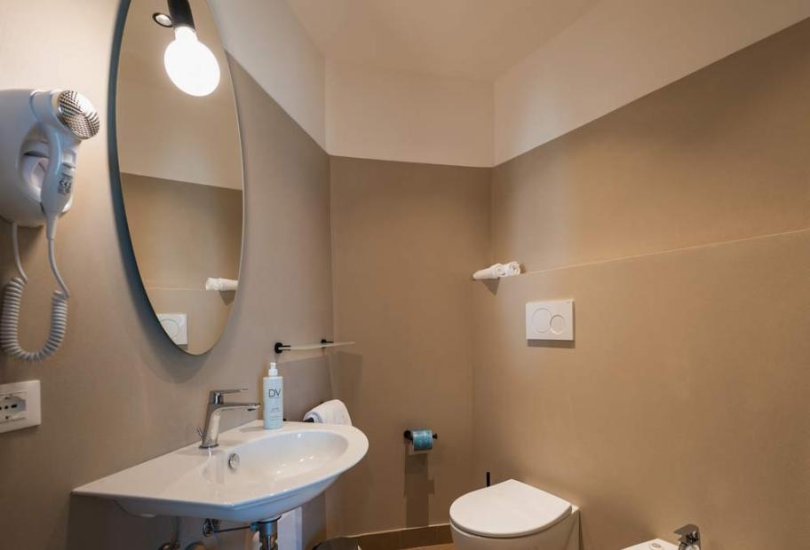 Modern, clean, and bright bathroom with elegant fixtures and soft colors.