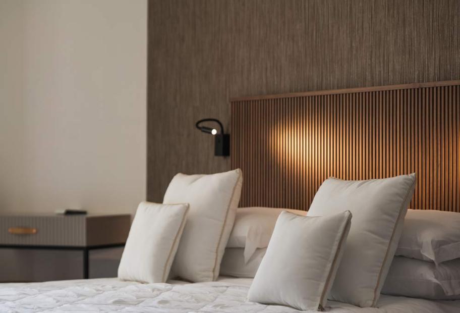 Elegant room with cozy bed and soft lighting, creating a relaxing atmosphere.