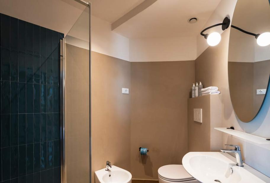 Modern, elegant, and bright bathroom with shower, bidet, and sleek sink.